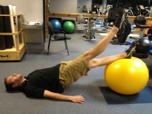 Exercise ball alternating leg lifts