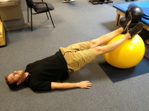 Straight leg bridge with exercise ball