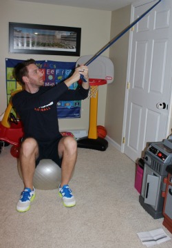 Downward chop with resistance band while sitting on exercise ball