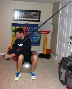 Downward chop with resistance band sitting on stability ball